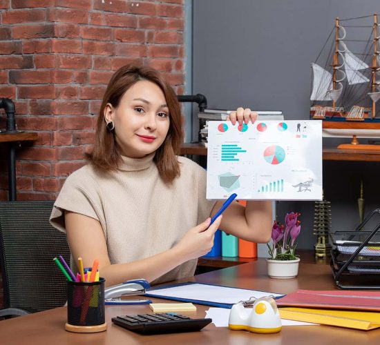 front view pretty woman showing diagrams working in office
